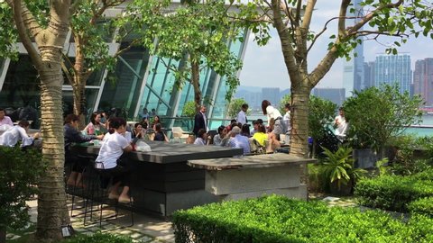 HONG KONG - SEPTEMBER 2019: People dine at the IFC Mall rooftop restaurant. It is a 4 storey shopping mall with many luxury retail brands and wide variety of restaurants.