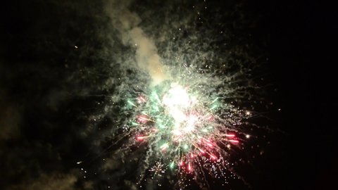 Beautiful fireworks celebrating New Year. Glowing and sparkle fireworks display. Colorful fireworks in night sky. Pyrotechnics. Concept: party, holidays, celebration, happy, birthday, celebration. 