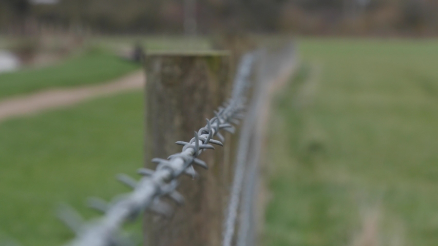 pulling barbed wire fence