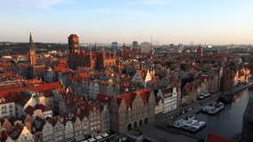 Gdansk, Poland. Aerial 4K reveal video of old city, Motlawa river and famous monuments: Gothic St Mary church, city hall tower,