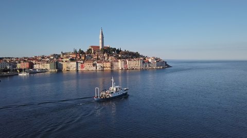 Morning aerial panorama of old town Rovinj with fishing ship, Istria, Croatia.