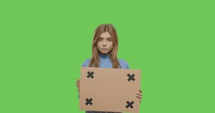 Thinking girl holding placard cardboard with tracking points or blank sign on Green Screen background , Chroma Key. isolated 4k video footage slow motion 60 fps
