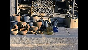 Handmade products and terracotta pots on the street shops of Haifa city by the Mediterranean sea. Historical archival footage in the 1970s of Israel.