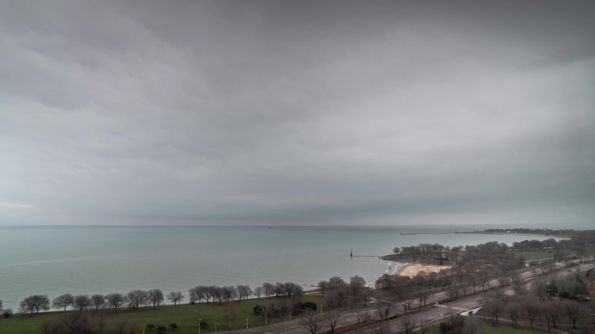 An aerial time lapse of thick clouds moving over Lake Michigan along Lake Shore Drive as dusk turns to night.