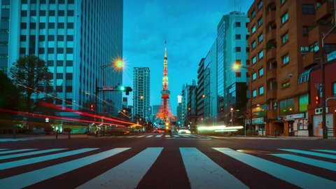 Time-lapse illumination view of business area street with view of Tokyo Tower in sunset night time. Night time Tokyo famous tourist attraction.Tokyo Olympic 2020 4K UHD video of Tokyo city in japan