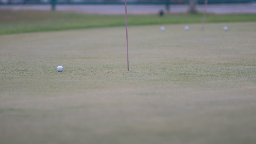 golfer putting golf ball in to the hole Royalty-Free Stock Footage #1044249442
