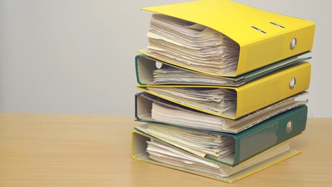 Plastic folders with documents. Multicolored stationery folders. Stack documents, stop motion animation 