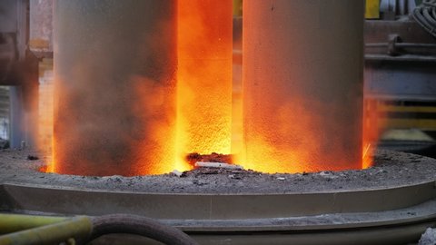 Fire and melted steel from a electric arc furnace. Close-up.