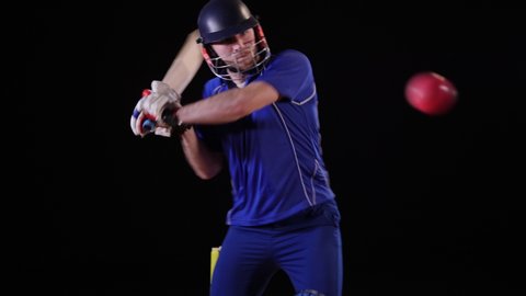 Cricket Batsman hitting the ball - Pull shot. Black background. Dressed in blue. One Day / TwentyTwenty  -4K Stock Video clip footage