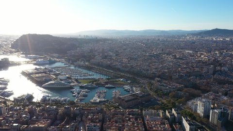 Mega yacht in Port of Barcelona aerial sunny day Spain Barceloneta neighbourhood and mountains 