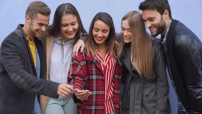Group of friends watching smart mobile phone - Teenagers addiction to new technology trends - Youth lifestyle, tech, social, millennial generation and friendship concept