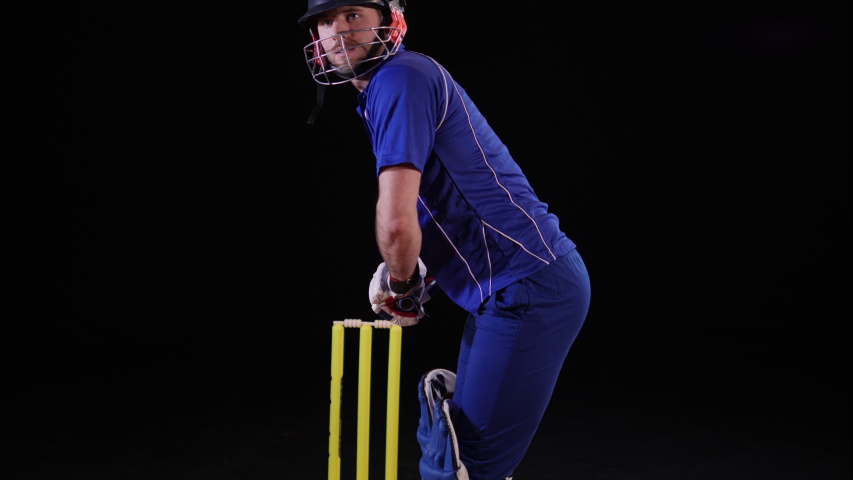 Cricket Batsman hitting the ball - Pull shot. Black background. Dressed in blue Royalty-Free Stock Footage #1044269698