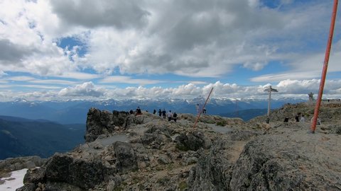 Peak of Whistler Mountain with tourist people visitors enjoying the scenic landscape view of the horizon