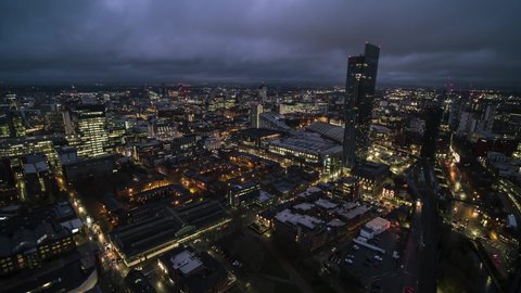 Iconic Skyline Establishing Bird Eye Aerial View Shot of Manchester UK City Skyline England United Kingdom at evening night drone helicopter