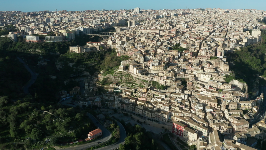 day aerial shot of Ragusa Superior flying backward revealing Ragusa Ibla