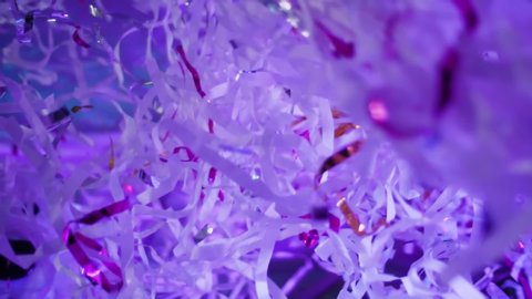 Colorful confetti sprinkling, scattering and glittering. Bright colored shredded paper confetti flying high. Paper party, shine tinsel, holiday, party or birthday, slow motion.