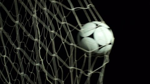 Goal scored in a soccer match. The black and white football hits the back of the net. Black Background, Super Slow motion