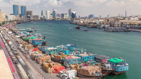 Loading a ship in port timelapse in Dubai, Deira creek, UAE. Aerial top view from above with many old boats and cargo ships