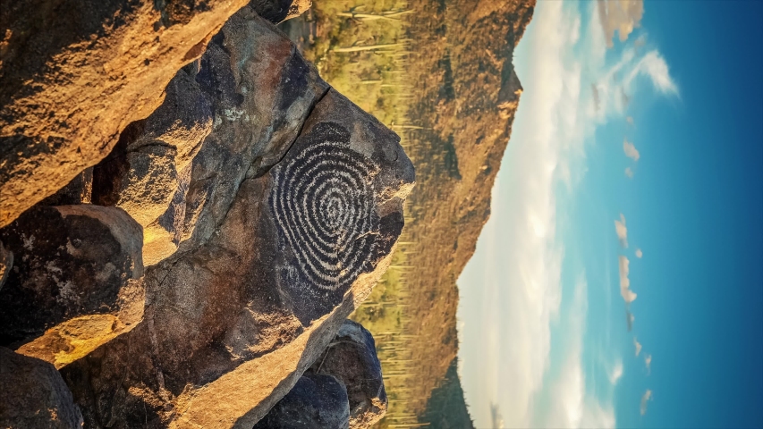A loopable vertical cinemagraph of a Native American Indian spiral petroglyph at Signal Hill in Saguaro National Park, Arizona