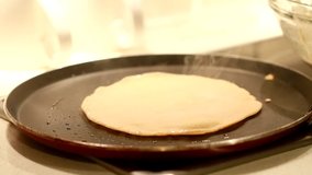 making of Indian traditional breakfast Dosa, dosai with wheat flour in a hot pan macro video