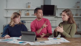 Creative team of diverse deaf-mute freelancers brainstorming, analyzing financial charts and data, sharing ideas and visions using sign language during work on new startup business indoors. - Powered by Shutterstock - Get 15% off with code: PIKWIZARD15