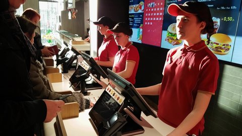 MINSK, BELARUS - December 13, 2019: Visitor orders food at McDonald's restaurant
