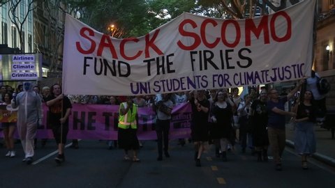 Brisbane, Queensland / Australia - January 10, 2020: Front of bushfire/climate action march with banner reading "Sack Scomo - Fund the firies". Uni Students for Climate Justice.