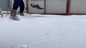 Young man cleaning snow winter with shovel after snowstorm yard. City service workers sweeping snow from the road. Russian snowy winter daily routine. Time lapse video.