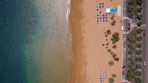 Top view of Las Teresitas beach, road, cars in the parking lot, golden sand beach and the Atlantic Ocean. Tenerife, Canary Islands, Spain