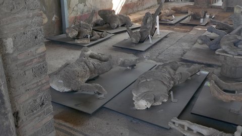 Left to right pan over plaster body cast of victims killed in Mount Vesuvius eruption in Pompeii, Italy