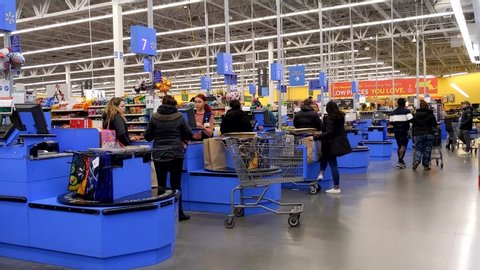Walmart store customers checkout at cashier counter lanes, Saugus Massachusetts USA, January 6, 2020