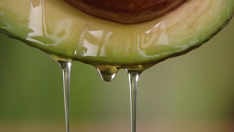 Fresh avocado and oil in slow motion