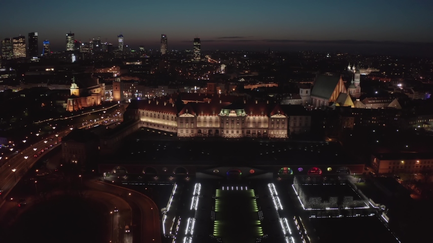 Aerial view of the old city of Warsaw.  Facade of the buildings is beautifully illuminated in the winter at night. Cityscape at dusk overlooking the royal palace and the square with a Christmas tree.
