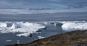 4k Timelapse Video clip of Icefjord in Greenland Iceberg landscape of Ilulissat icefjord with giant icebergs. Fishing boats passing by. Timelapse hyperlapse with Icebergs from melting glacier. Arctic