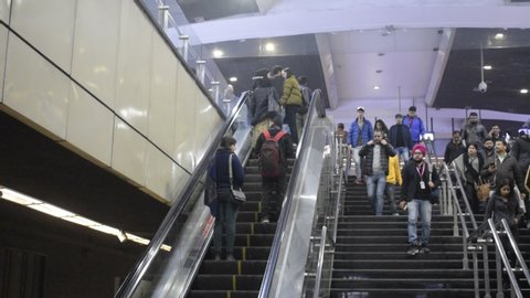 Delhi, Indian 2019 : Daily passengers using escalators and stairs in a metro station. Metro train is most preferred mode mode of travel in Delhi NCR for office goers. 
