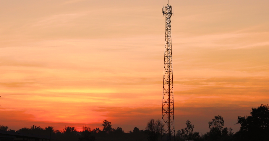 Telephone pole against a beautiful sunrise or sunset background, orange sky,Rural nature background