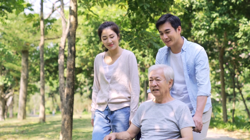 Young asian couple taking father out for a walk outdoors in park | Shutterstock HD Video #1044432514