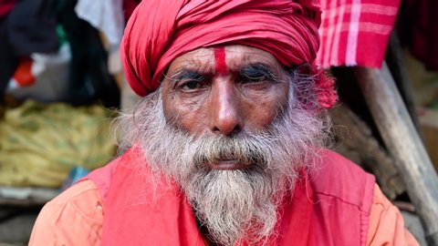 KOLKATA, INDIA, January 2020 : Portrait of an Indian old man or sadhu (religious ascetic or holy person) looking at the camera. Kolkata, India.