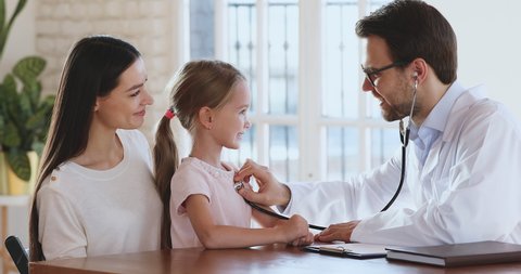 Smiling professional male doctor pediatrician examining child with parent mom check heartbeat listen kid heart with stethoscope give high five do medical healthcare children pediatric checkup concept