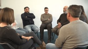 Support group people sat in circle for therapy Counselling session - One man talks while the others listen. Mental Heath, Alcoholic  -4K Stock Video clip footage