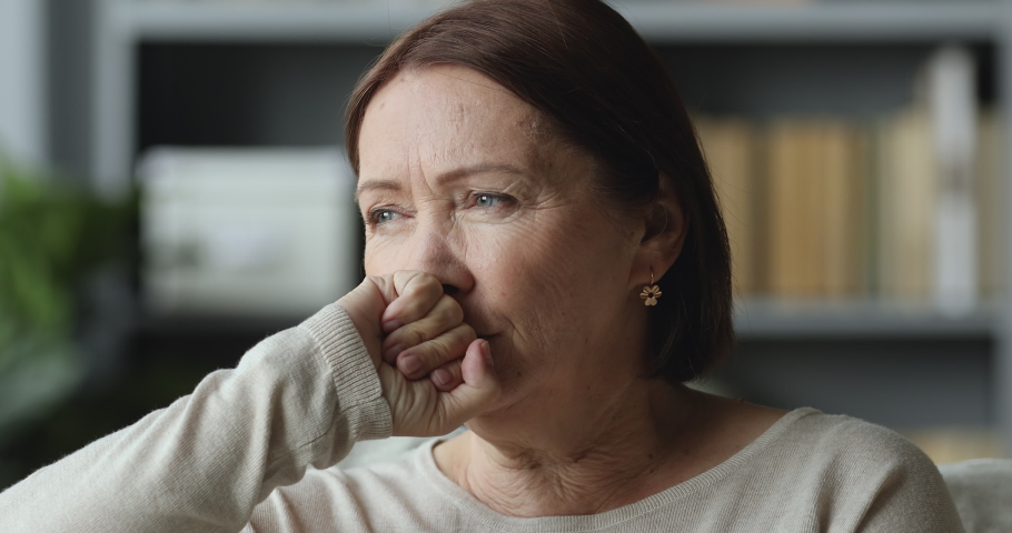Thoughtful sad worried middle aged elder woman looking away think of loneliness grief sorrow concept, serious depressed old mature grandma lost in thought feel concerned alone at home, close up view | Shutterstock HD Video #1044454894