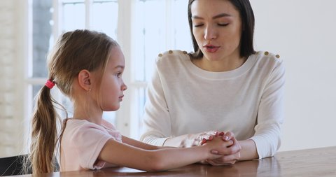 Caring young mother children psychologist hold hand talk comforting sad kid girl child daughter help with problem give psychological support in trust honest conversation at therapy session concept