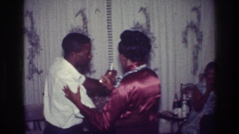 HARLEM NEW YORK USA-1976: A Couple Dancing Indoors While Someone Else Sits Nearby And Claps
