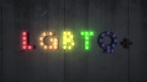 LGBT light bulbs sign on wooden background. LGBT stands for lesbian, gay, bisexual, and transgender.