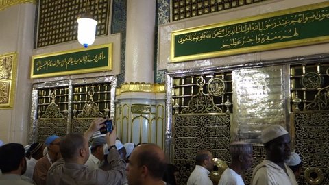 MEDINA, SAUDI ARABIA - CIRCA 2013: Muslim pilgrims visiting Prophet Mohammad’s holy tomb and his companions inside the al-Masjid an-Nabawi in Al Madinah, Kingdom of Saudi Arabia.