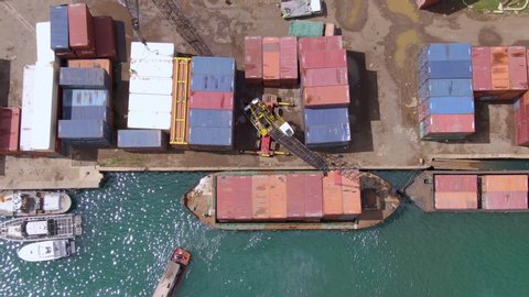 Aerial view of an African Shipping port, tug boat and shipping containers in developing nation of East Africa. Hell Ville on Nosy Be, Madagascar.