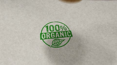 100 percent organic stamp and hand stamping impact animation. Ecology, bio, gmo free, natural and healthy diet 3D rendered concept.