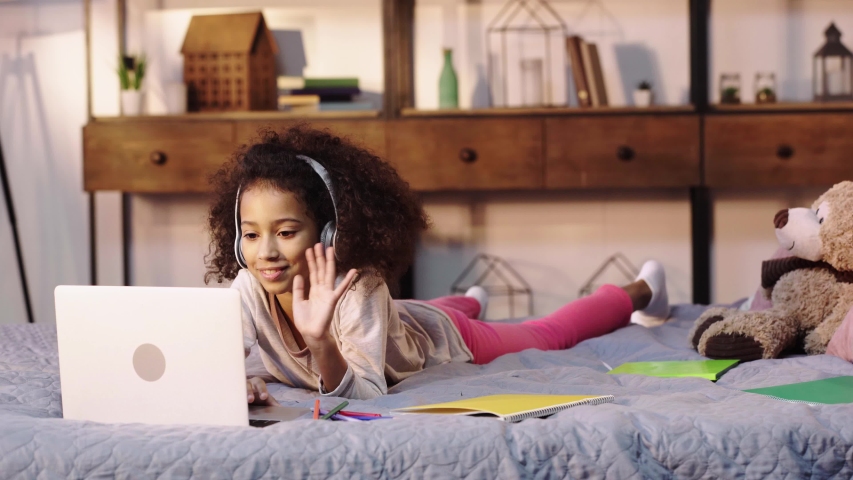 african american child having video call on laptop in bed Royalty-Free Stock Footage #1044490006