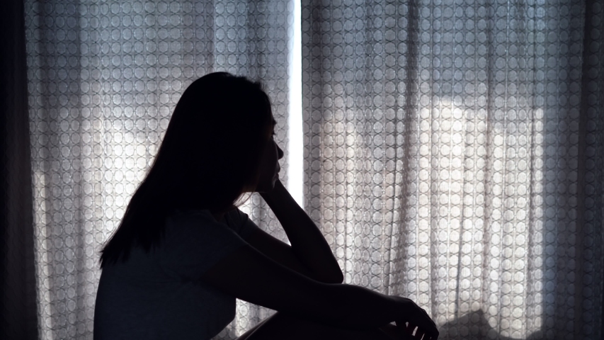 Lonely young woman depressed and stressed sitting in the dark bedroom, Negative emotion concept | Shutterstock HD Video #1044491929