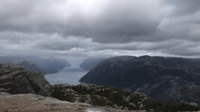High mountain landscape in hazy weather. View from Preikestolen mountain in Norway from Pulpit Rock the ascending path, Lysefjord, Norway. Scandinavian famous landmark. Breathtaking video 